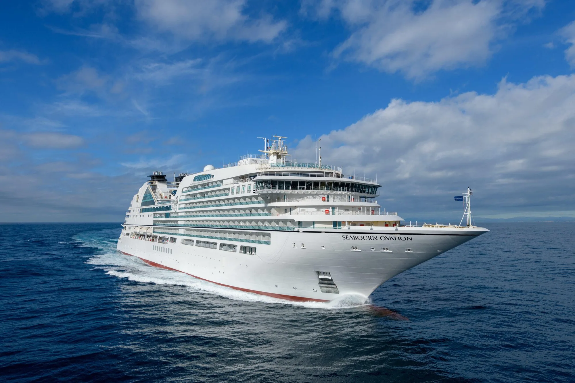 Seabourn Ovation at sea under a blue sky
