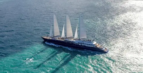 An Orient Express sailing yacht under sail on a turquoise sea
