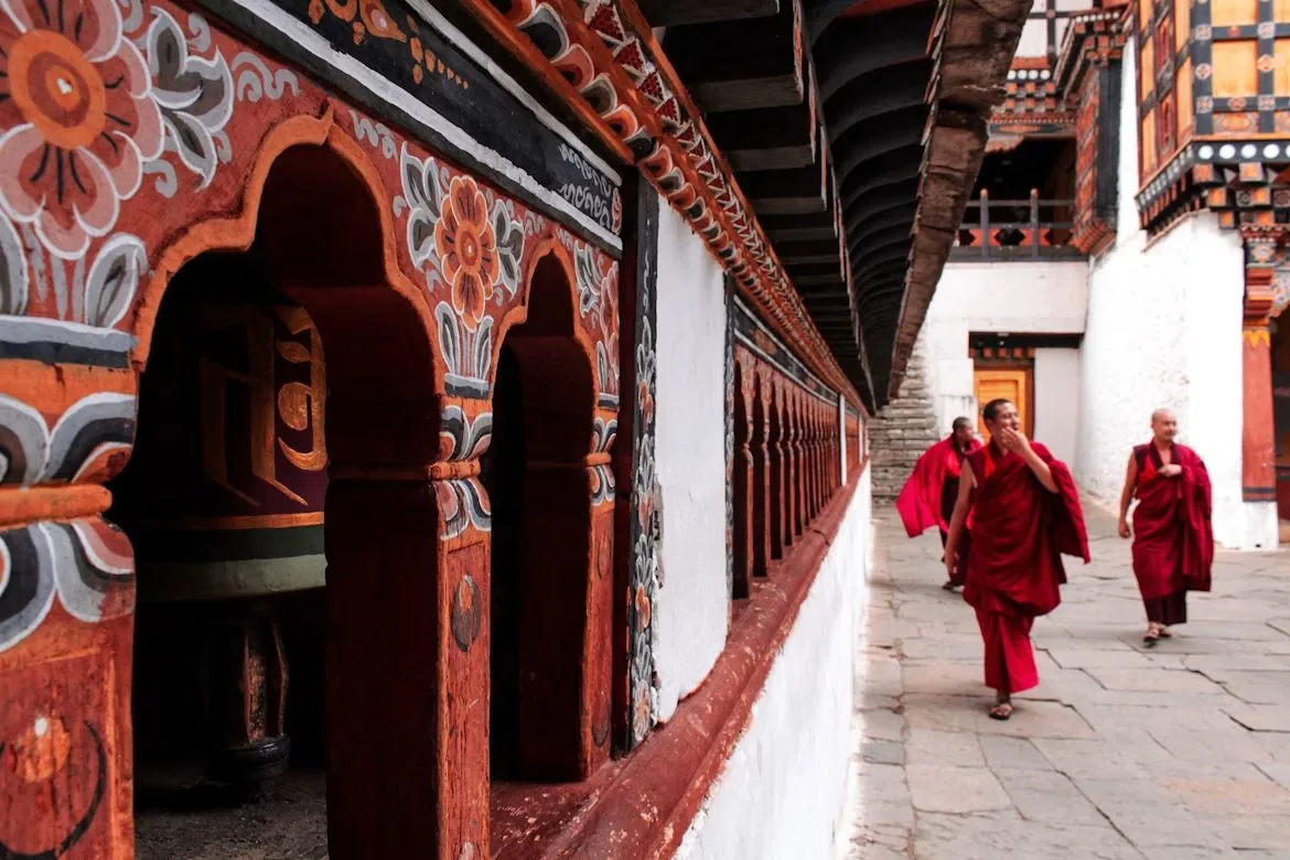 Monks crossing a dzong courtyard.