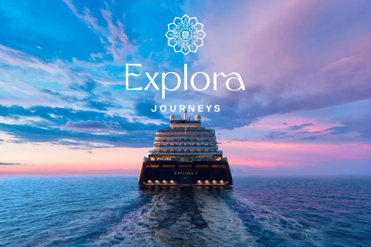 Explora II sailing at sunset beneath the Explora Journeys logo