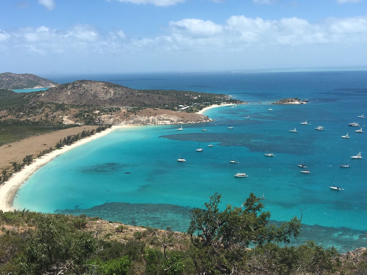 Looking down over a turquoise bay and anchored yachts on Lizard Island