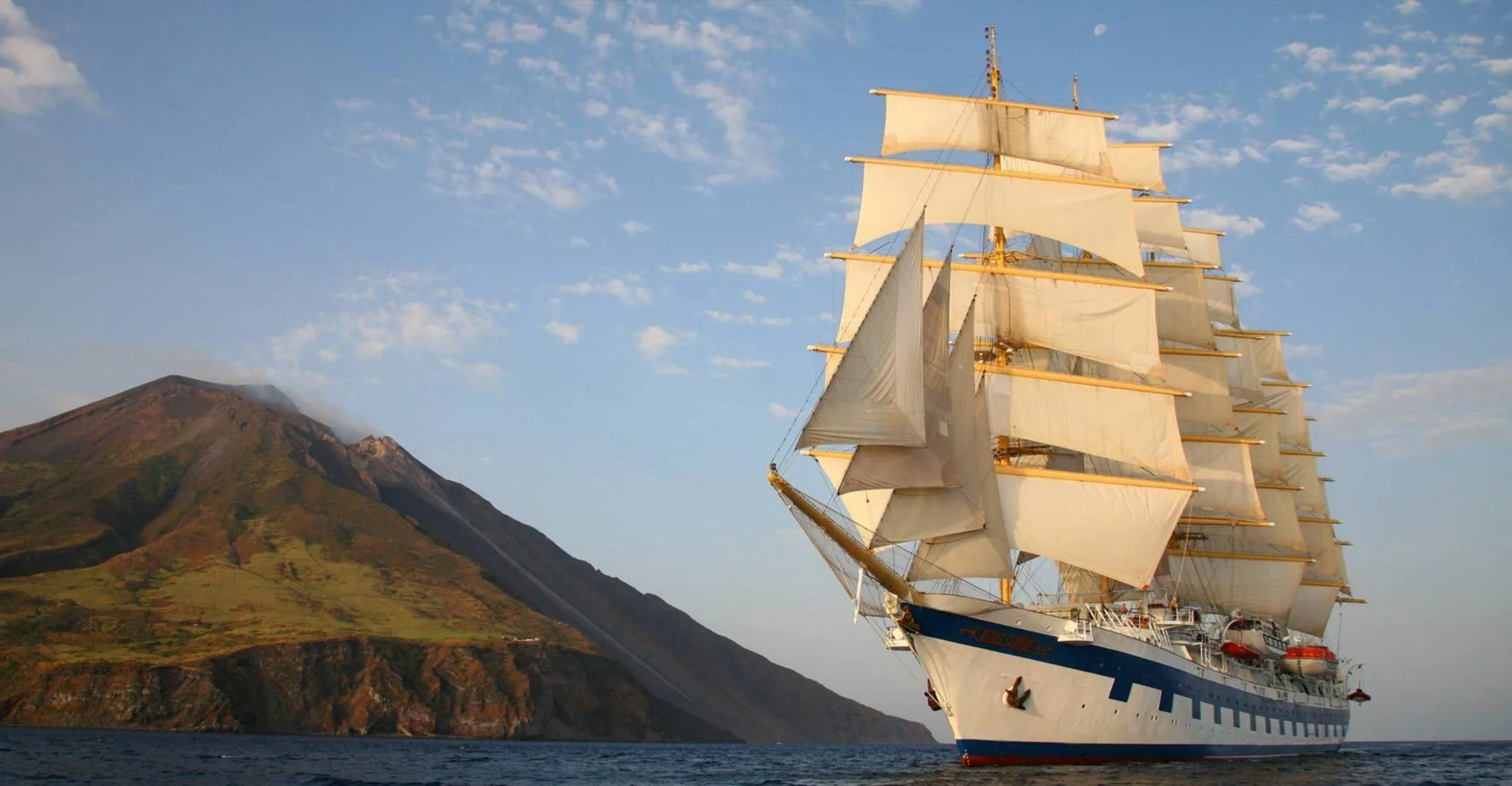 Royal Clipper under full sail off the volcanic island of Stromboli, Italy