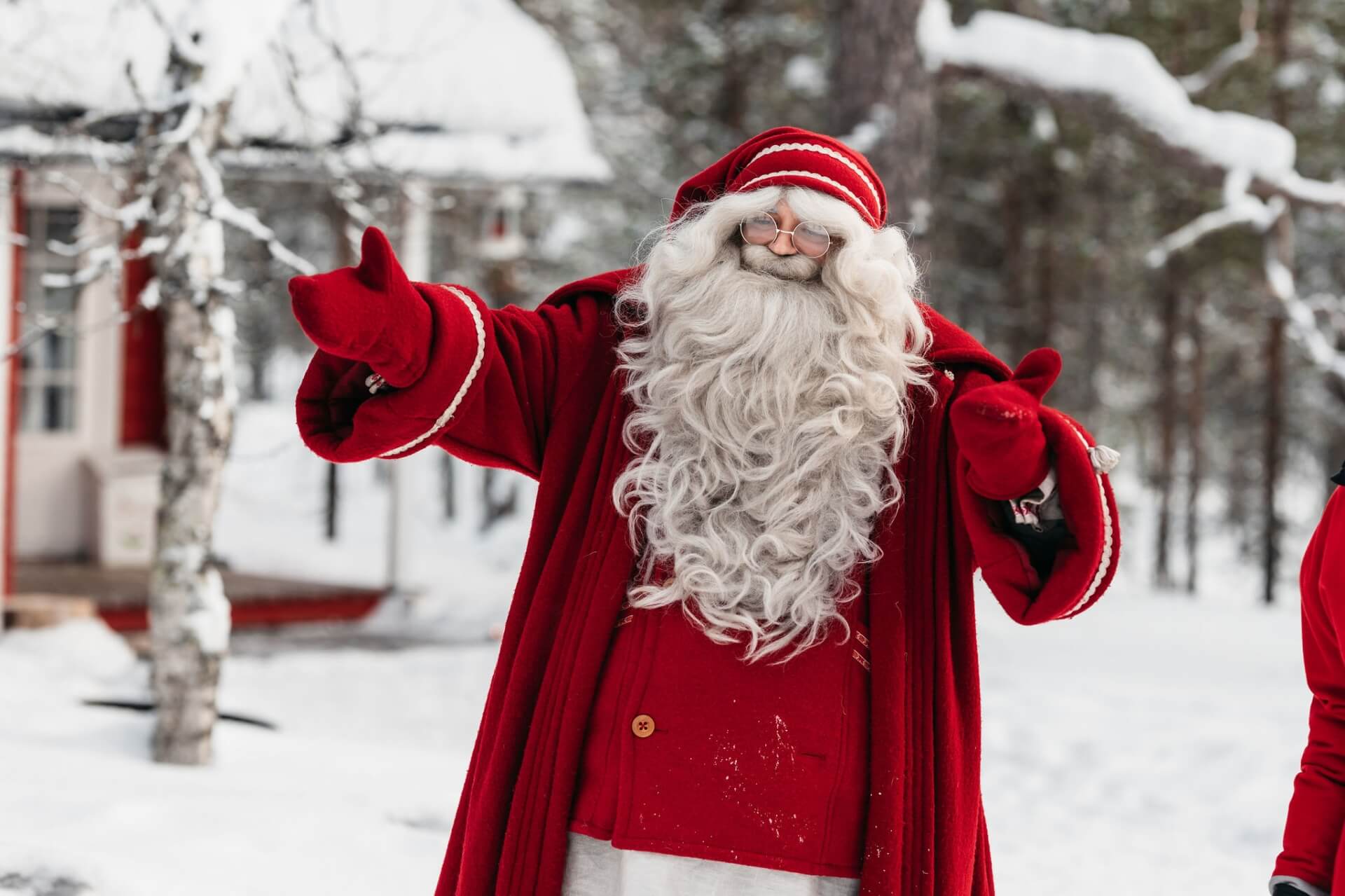 Santa Claus in a red wool coat in the snowy forest