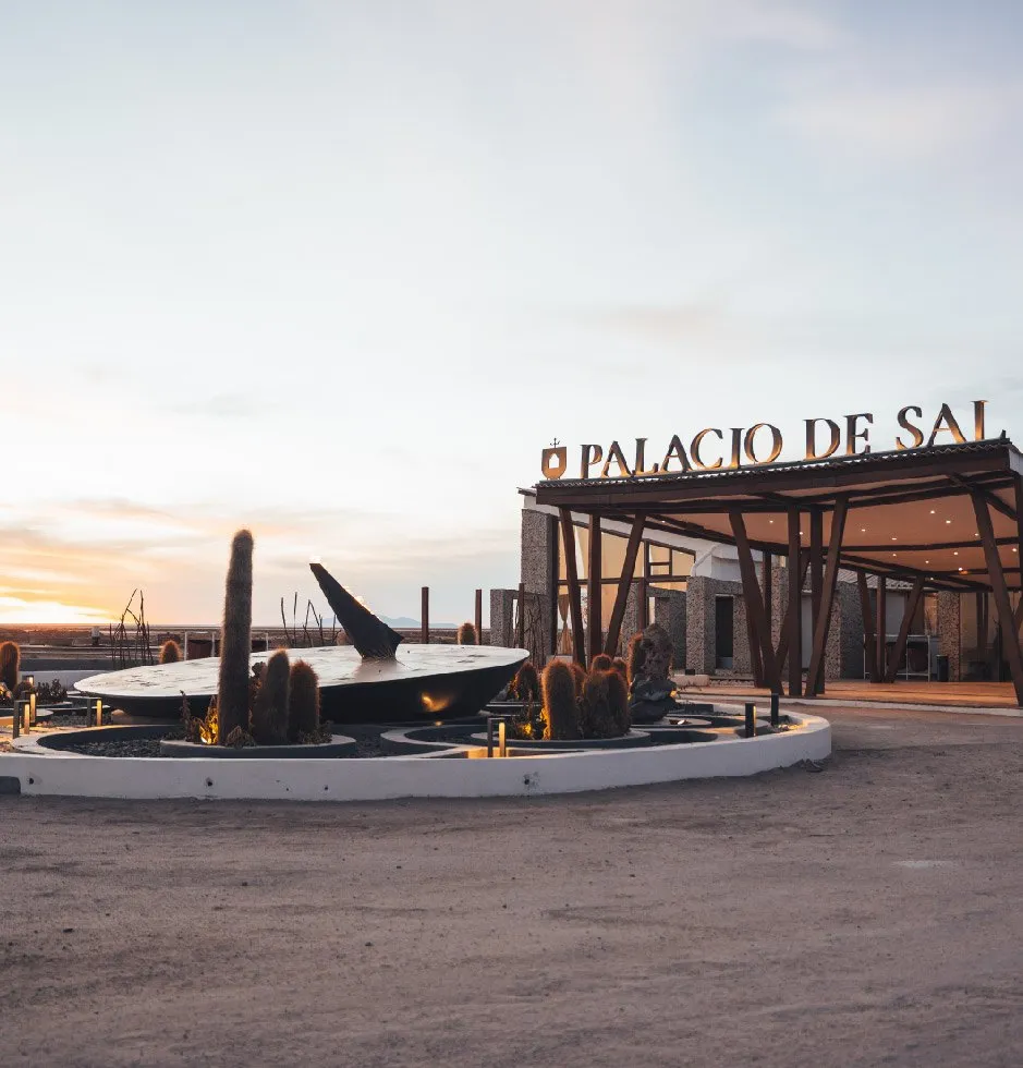 The Palacio de Sal entrance at sunset, with a sculpture garden of cacti