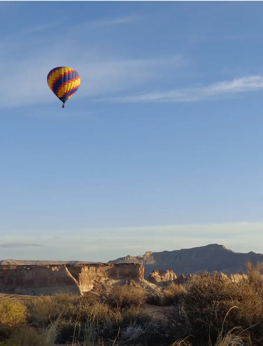 A hot air balloon drifting above the desert near Amangiri