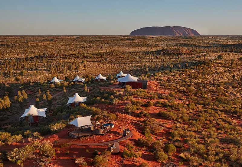 Longitude 131° tented pavilions in the red desert, with Uluru on the horizon