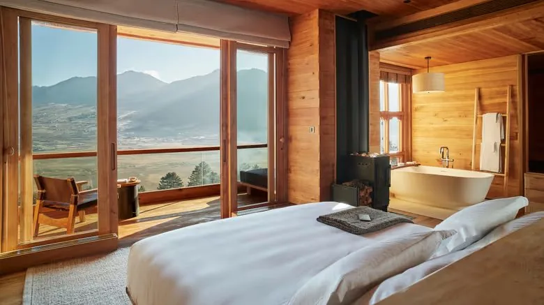 A suite with valley views and a bathtub beside the window.