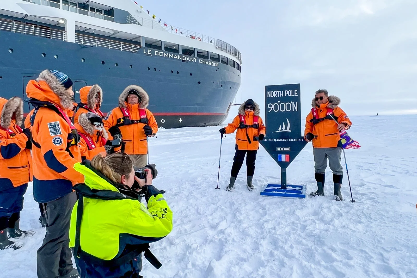 Guests standing on the sea ice at the Geographic North Pole