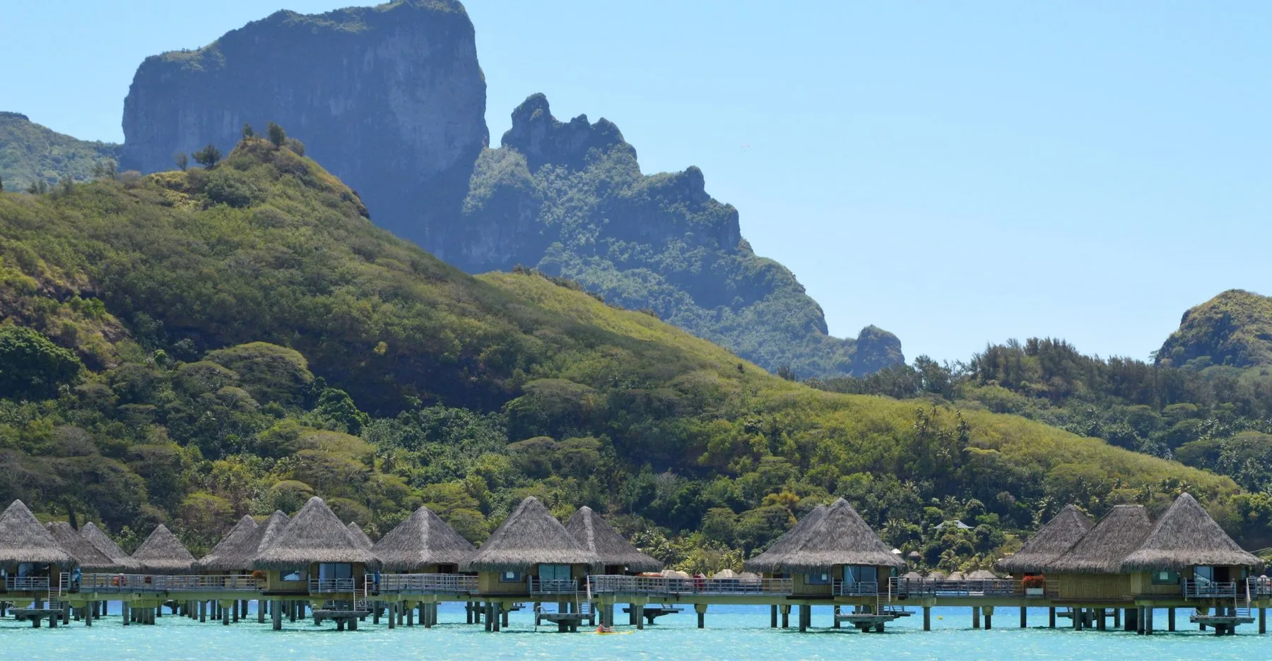 Overwater bungalows on a turquoise lagoon in Bora Bora, French Polynesia